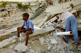 Clifford Berrette, 11, sits on the rubble of his neighbor's home 
in Port-au-Prince, Haiti, on Wednesday, January 27, 2010